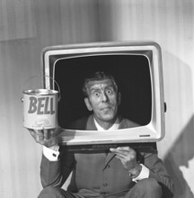 Television in the 1950s. A man wearing a televison set over his head, with the screen taken out,
