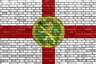 Flag of Alderney painted on brick wall