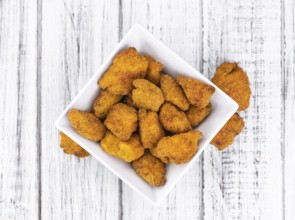 Homemade Chicken Nuggets on vintage background (selective focus, close-up shot)