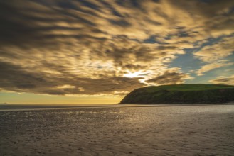 Sunset and dark clouds over the St Bees Heritage Coast near Whitehaven in Cumbria, England, UK