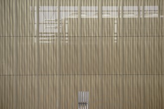 The outer façade of a combined heat and power plant made of perforated metal panels behind which