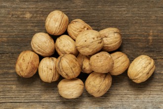 Walnuts lying on an old brown board. view from the top