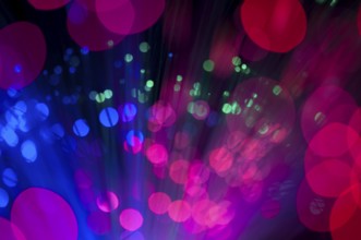 Blue and pink festive lights and circles background. Blurred christmas lights