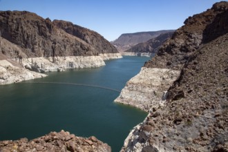 Colorado River reservoir near the dam with coloured rock face