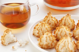Plate of coconut macaroon cookies and cup of tea