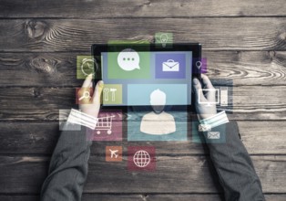 Top view of woman in business suit sitting at wooden table with tablet pc