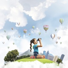 Concept of careless happy childhood with girl looking in future