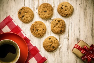 Cup of coffee and cookies on rustic wooden table