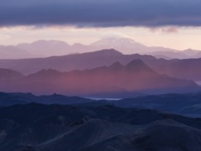 Cloudy mood and evening light at sunset, view from Mount Sveinstindur, volcanic landscape,