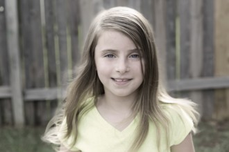 Blond kid girl happy smiling portrait outdoor at backyard