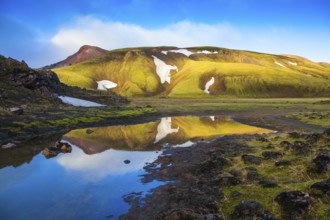 Light golden dawn illuminates the mountains and glaciers national park Landmannalaugar. The sunrise