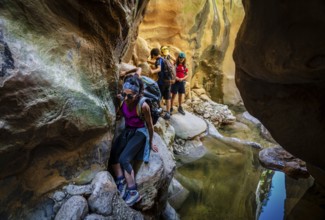 Walkers dodging waterlogged stretches, Torrent de Pareis, Sa Calobra, Majorca, Balearic Islands,