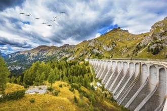 Powerful dam blocked the lake. Mountain Lake Lago di Fedaia, Dolomites. The concept of ecological