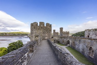 Old castle with towers and strong walls, picturesque surroundings, blue sky
