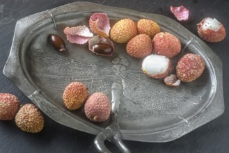 Lychees on an Art Nouveau plate (pewter)
