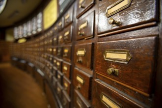 Wooden drawers with metal ornaments in an old-fashioned library. Wooden boxes with index cards in