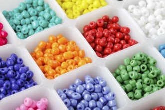 Close up multi colored beads heap in box