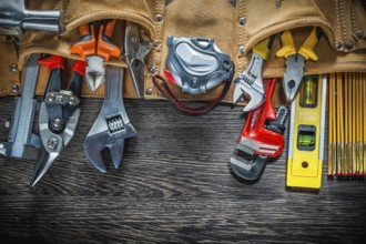 Tool belt with construction tooling on wooden board