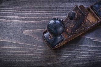 Vintage grunge planer on wooden board construction concept