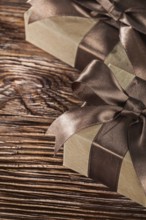 Brown present boxes with tied bow on vintage wooden board