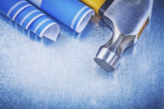 Blue blueprints claw hammer on metallic background