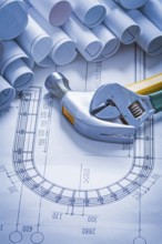 Claw hammer adjustable key and collection of blueprint rolls construction concept