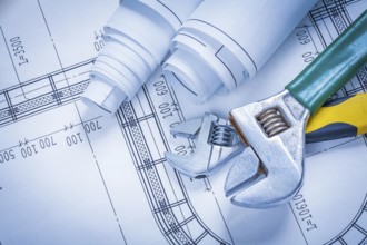 Adjustable spanners and blueprint rolls construction concept
