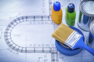 Blueprint with paint brush metal cans plastic bottles and adhesive household tape maintenance