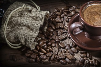 Poured beans from sack and clay coffee cup