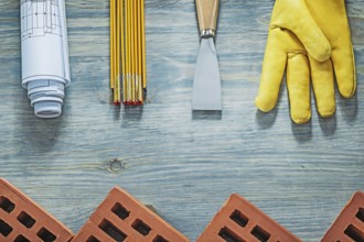 Assortment of bricklaying tools on wooden board building concept