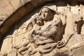 An old baroque engraved sculpture of Mary and Jesus over an entrance to the Cappella della Croce di