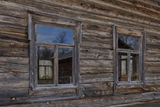 Windows on a weathered old log building, Lapland, Finland