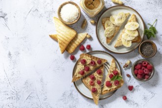 Sweet dessert sandwich breakfast. Tasty toasted with peanut butter, banana and raspberry on a gray