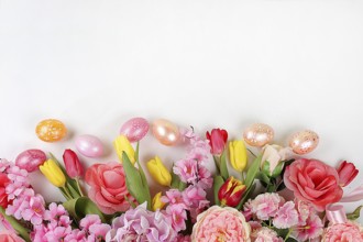 Festive easter banner, spring composition with decorated homemade eggs and blooming flowers,