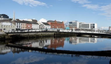 Cork, Ireland, February 24 2023: Mary Elmes pedestrian bridge with people crossing Cork Ireland
