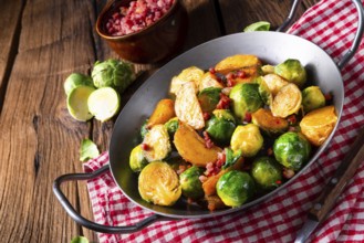 Brussels sprouts potato pan with bacon in a rustic style