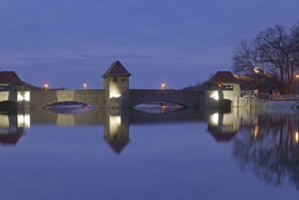The illuminated Palmengarten weir in the blue hour. Leipzig, Saxony, Germany