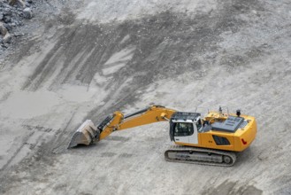 Mining in the granite quarry. Working mining machine, digger. Mining industry