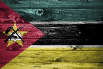 Mozambique flag on wooden planks background wood flag