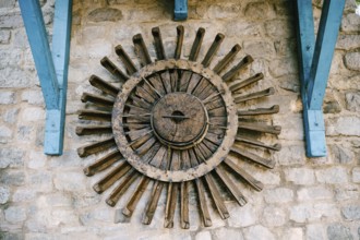 The wheel of a water mill. The old wooden wheel of the water mill is used as an element of decor on