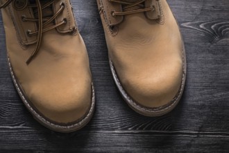 Safety working boots on wooden board construction concept