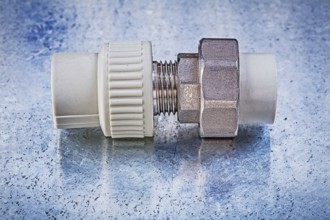 Pipe connectors on metallic background construction concept