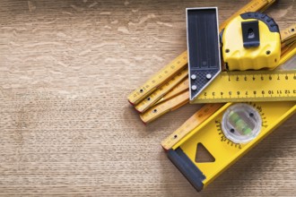 Working tools of measurement on oaken wooden board construction concept
