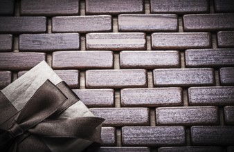 Packed gift box on wooden wicker matting holidays concept