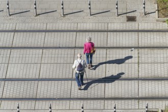Old pensioner couple on their way through the city centre