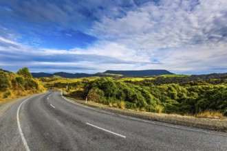 The road to Knight's Point Lookout. Asphalt highway among yellowed autumn vegetation. Picturesque