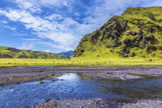 Pakgil Canyon - green grass and moss on the rocks. At the bottom of canyon flows small fast creek.
