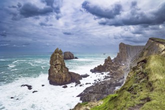 Powerful surf waves with a foam crest. Cantabria. Windy stormy day on the Atlantic coast. Rocky