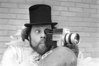 In the 1970s. A man is filming with a amateur film camera. The film was then developed and shown on