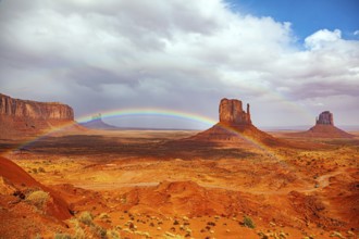 The bright rainbow all over the sky. Monument Valley is a unique geological formation in Arizona